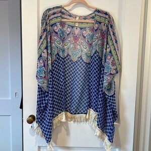 Candy rose swim coverup with fringe detail at bottom.